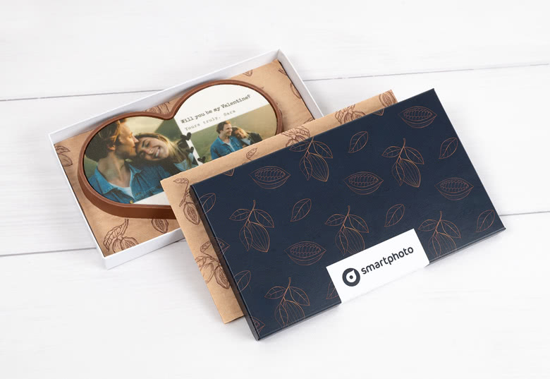 Personalised chocolate heart with custom photo and text, presented in a decorative navy blue box with leaf patterns.