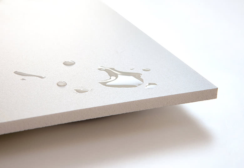 Close-up of a white refill card with water droplets on its surface, highlighting its water-resistant feature and smooth texture.
